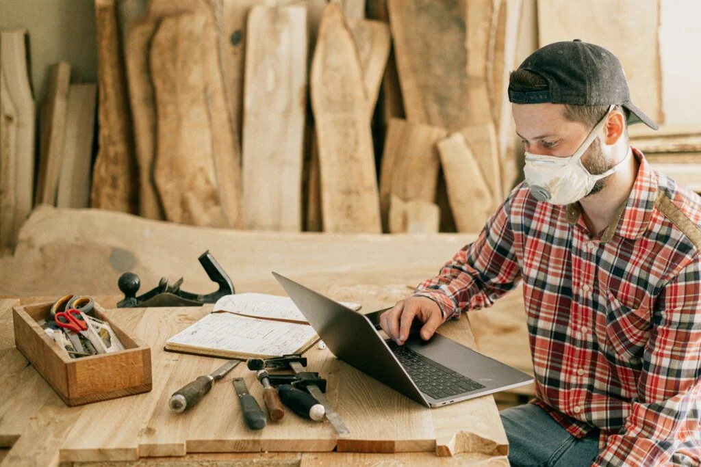 Skilled craftsman customizing professional furniture using traditional tools and modern technology, designed by New Elements.